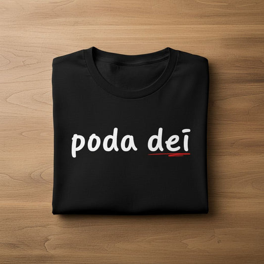 Folded black shirt with 'poda dei' text on a wooden surface