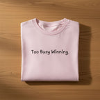 Pink oversized cotton T shirt with Too Busy Winning. text printed in the center folded – TRESSNY