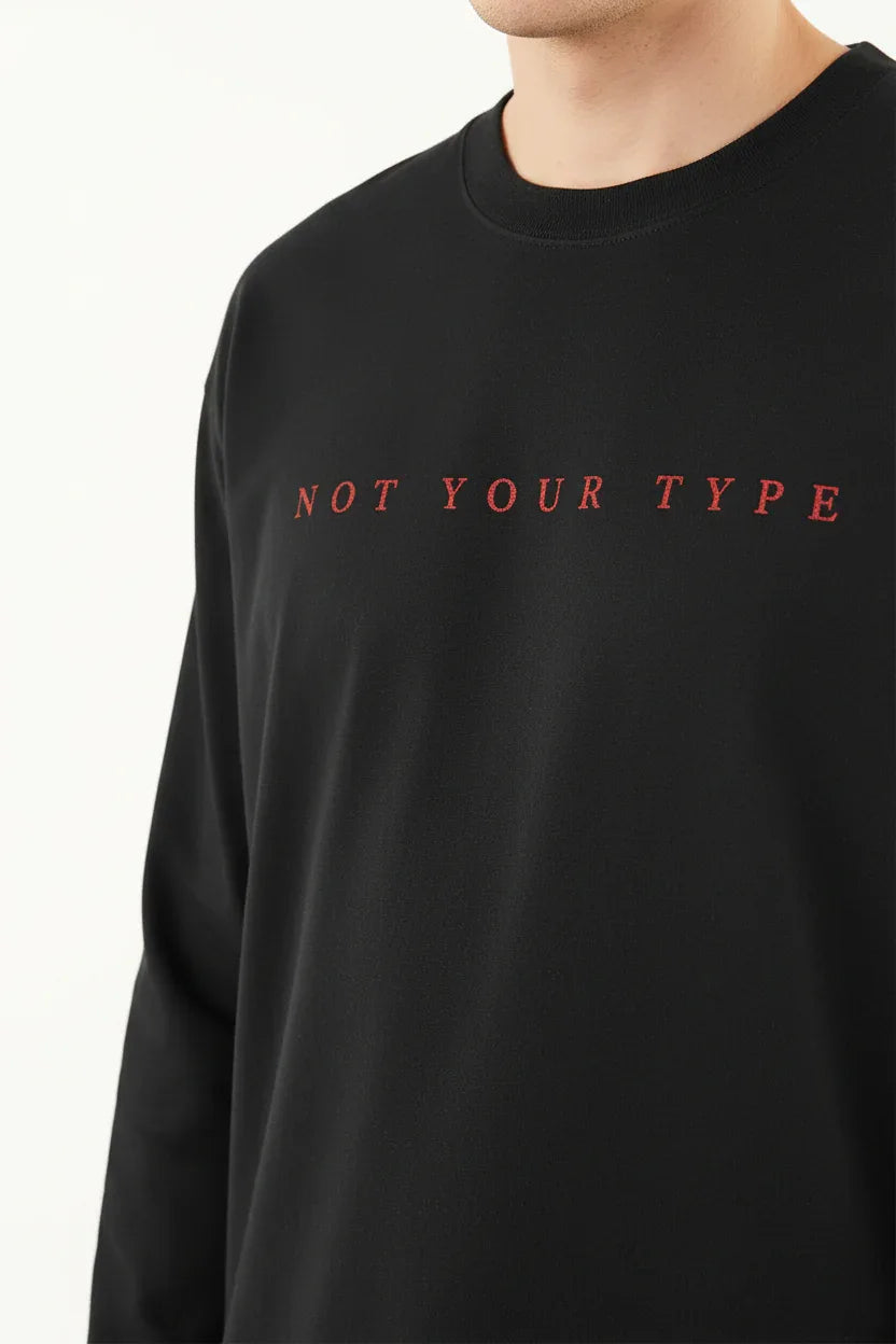 Not Your Type text detail - close-up of red typography on black tee