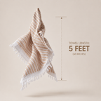 Towel with tassels and measurement text on a beige background